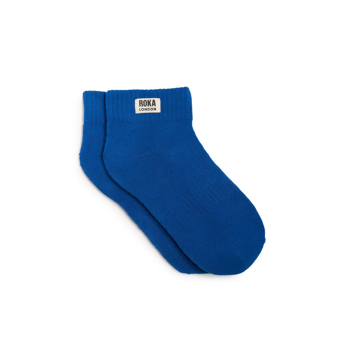 A pair of bright blue socks with the brand name 'Roka' visible on the ankle area.