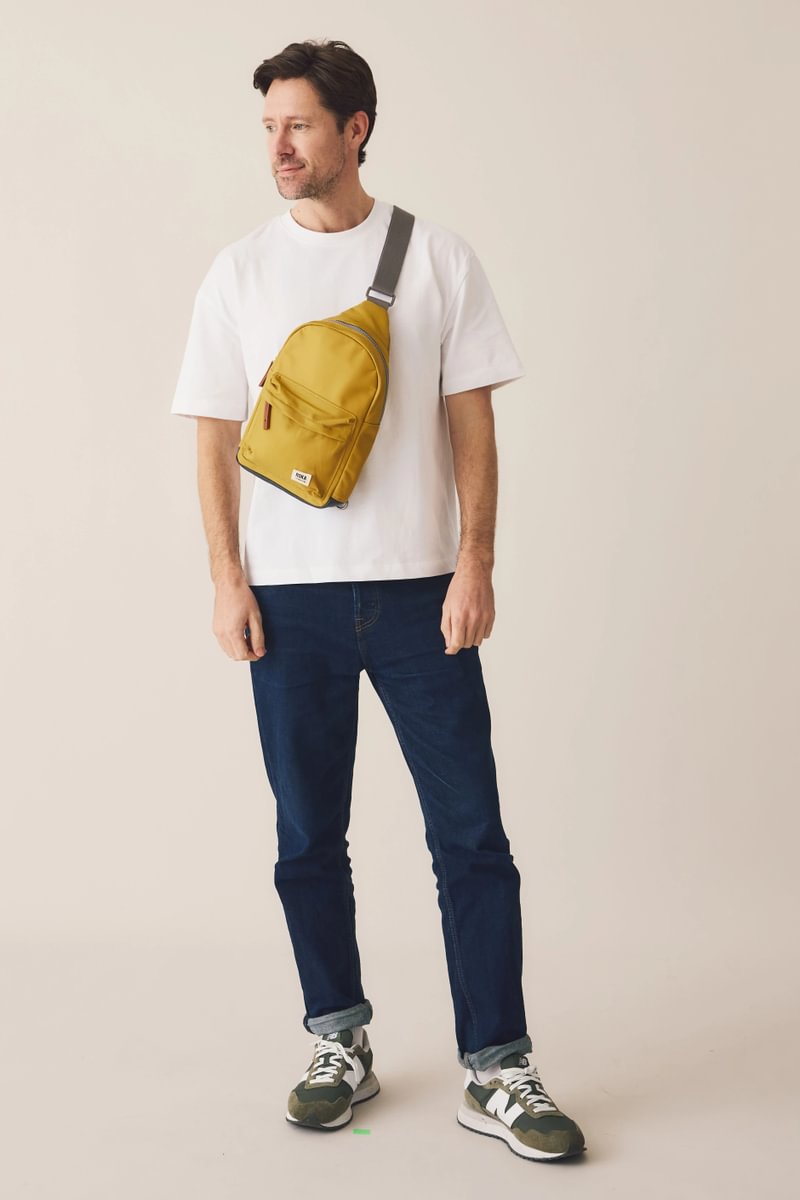 Willesden Sling Bag in Brown Dot on model, 6'0"